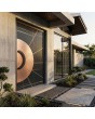 PIVOT Sahara - aluminum pivot door covered with Sahara Noir sintered quartz and copper sheet